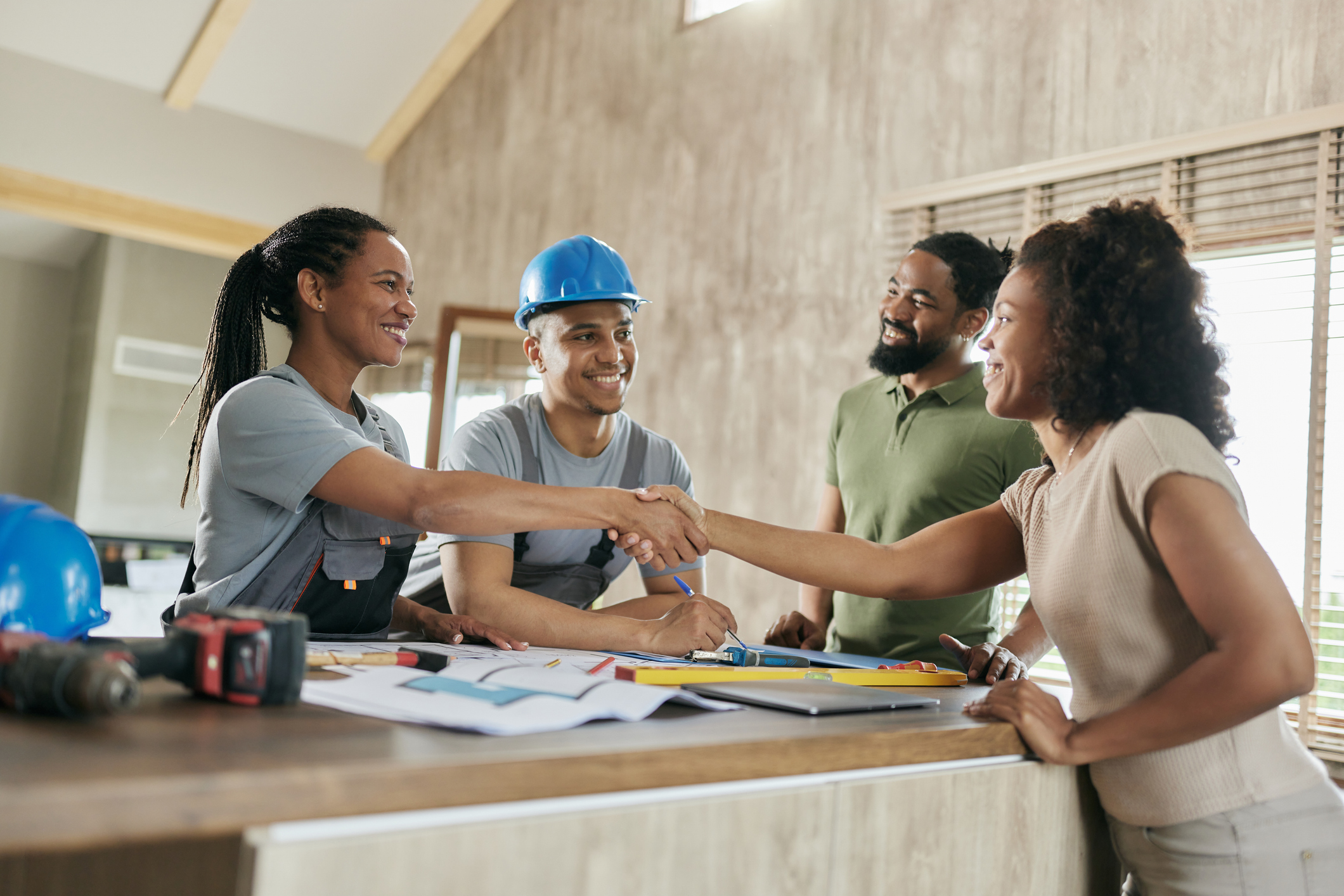 Homeowner and trades shaking hands over renovation plans